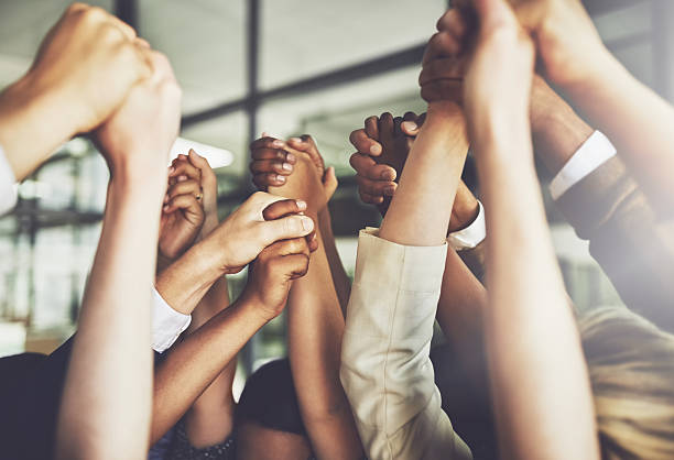 Together we can do anything Cropped shot of a group of businesspeople holding hands dedication stock pictures, royalty-free photos & images