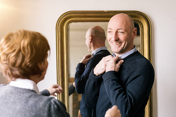 istock man getting dressed in front of a mirror 639339250
