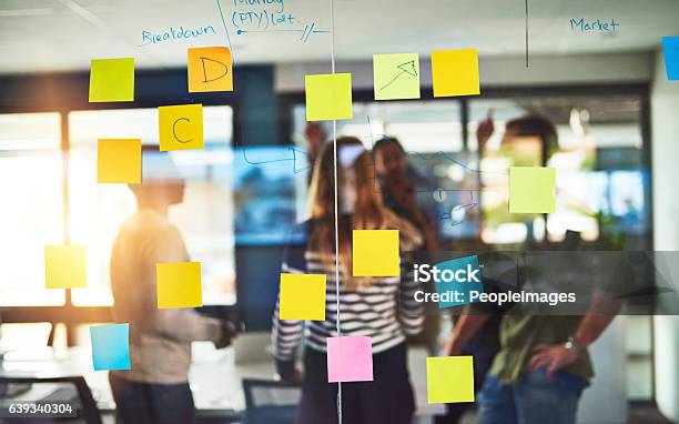 Creative Thinkers In Their Natural Habitat Stock Photo - Download Image Now - Adhesive Note, Wall - Building Feature, Defocused