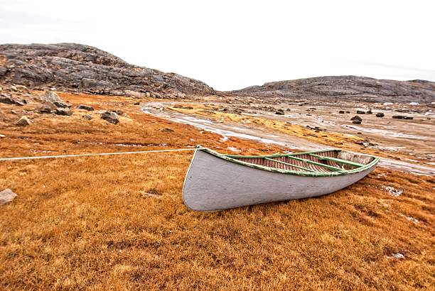 Inuit boat pulled on shore, Baffin Island, Nunavut, Canada. stock photo