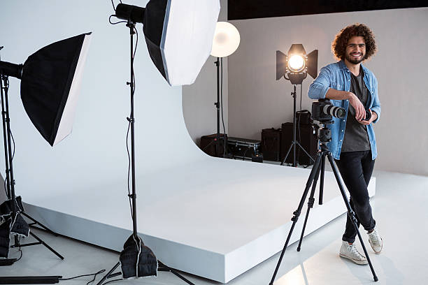 istock Happy male photographer standing in studio 639341626