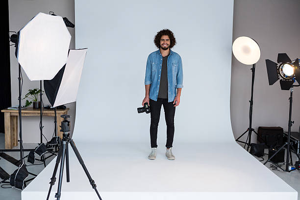 istock Happy male photographer standing in studio 639341654