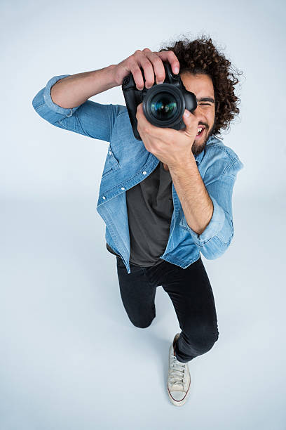 istock Photographer with digital camera in studio 639341872