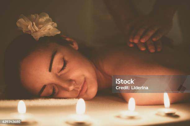 Woman Enjoying A Massage Treatment Stock Photo - Download Image Now - Massaging, Candle, Massage Therapist