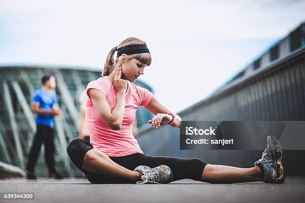 Athlete Checking Out Her Heart Rate Stock Photo - Download Image Now - Activity, Adult, Adults Only