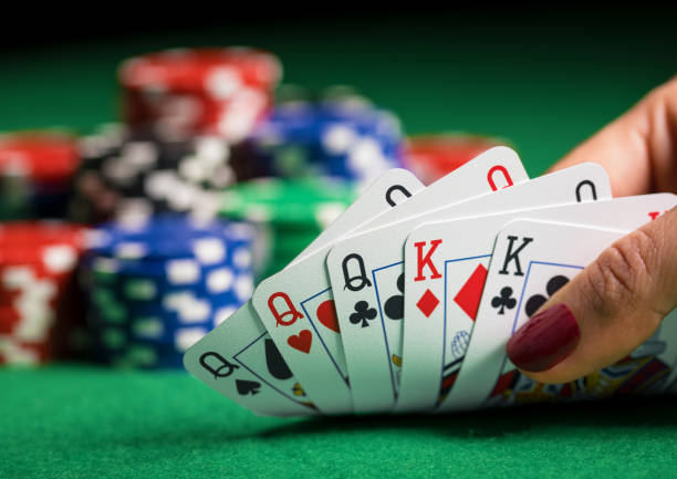 istock Person playing poker and looking at cards 639345296