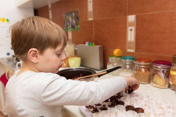 istock Little boy making cookies 639346160