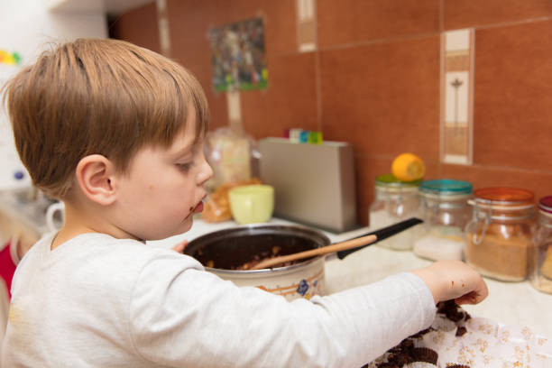 istock Little boy making cookies 639347056