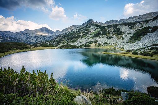 Beautiful lake surrounded by mountains, ripple on the lake surface