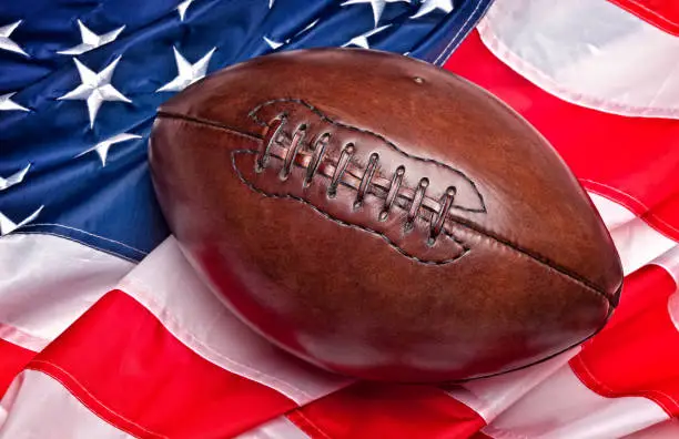 american football ball and old  glory flag