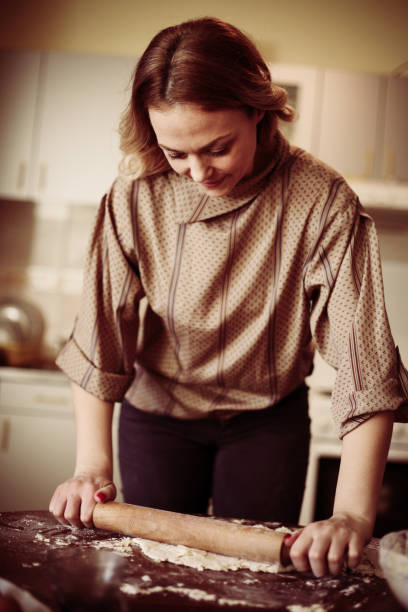 istock Blonde woman baking cookies. 639352758