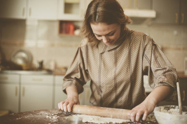 istock Blonde woman baking cookies. 639352944