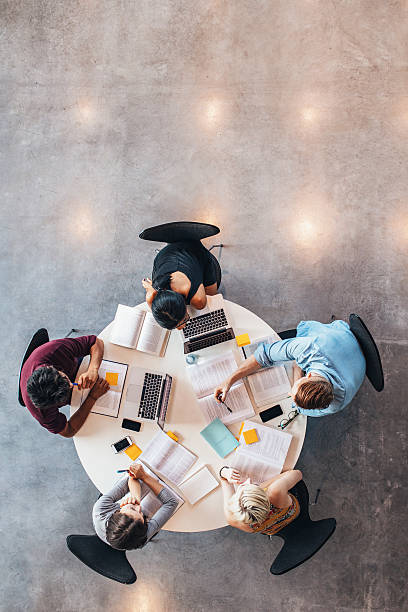 istock Group of students studying together 639354894