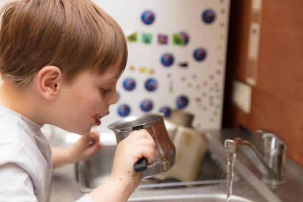 istock Little boy making cookies 639355284