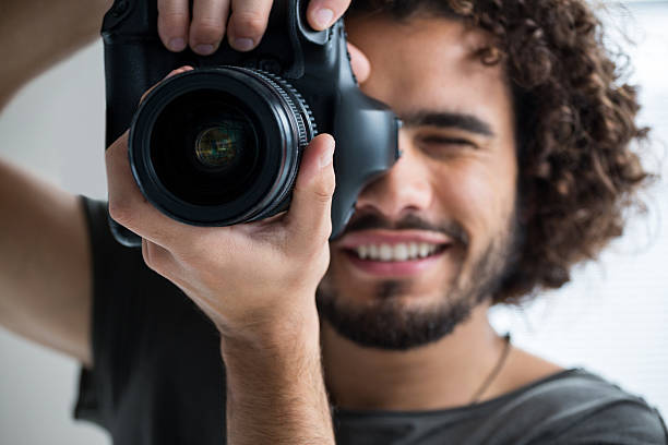 istock Male photographer with digital camera in studio 639356496