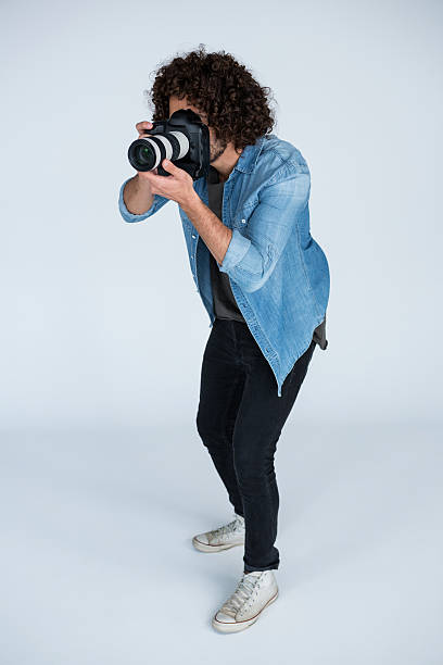 istock Photographer with digital camera in studio 639357506