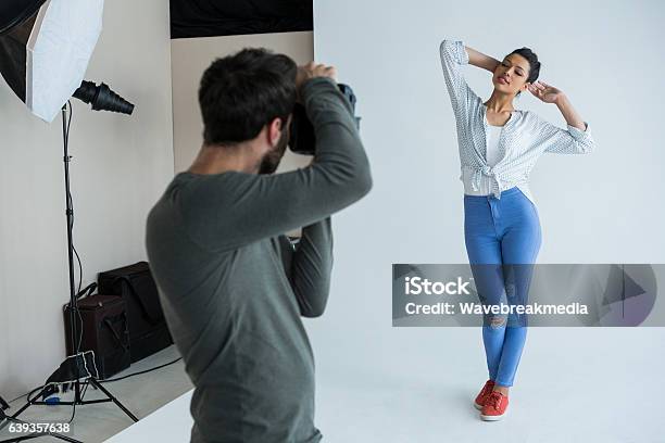 Female Model Posing For Photographer Stock Photo - Download Image Now - Photo Shoot, Fashion Model, Studio - Workplace