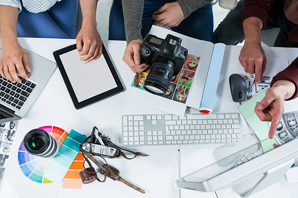 istock Team of photographers working over computer at desk 639357852