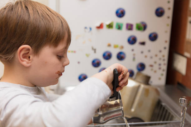 istock Little boy making cookies 639357856