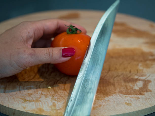 istock cutting tomato on a wooden board 639358226