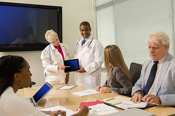istock Doctors use technology and meet with hospital board members. 639359258