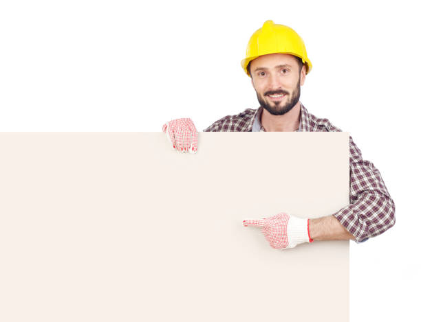 istock Handyman pointing at blank board 639360778