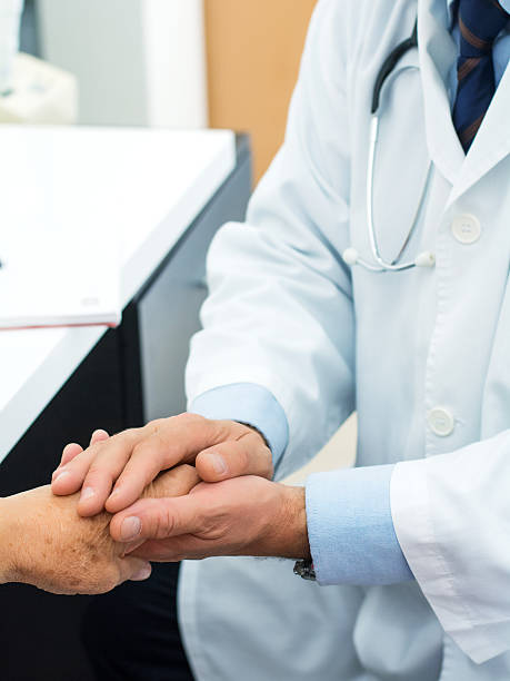 istock Doctor holding an old woman's hand 639360788