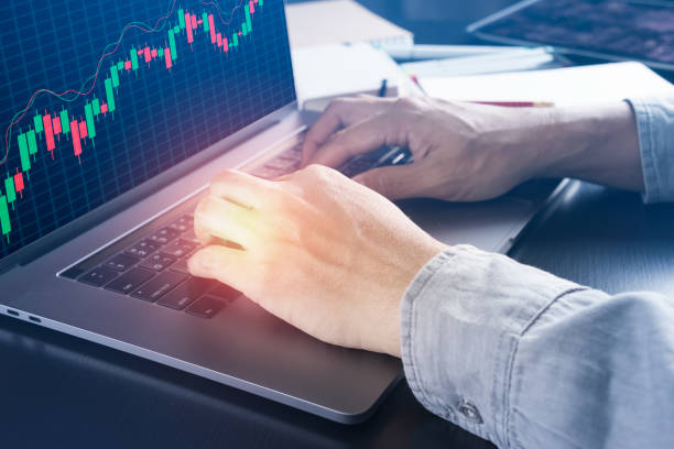 istock businessman checking at candlestick chart 639361258