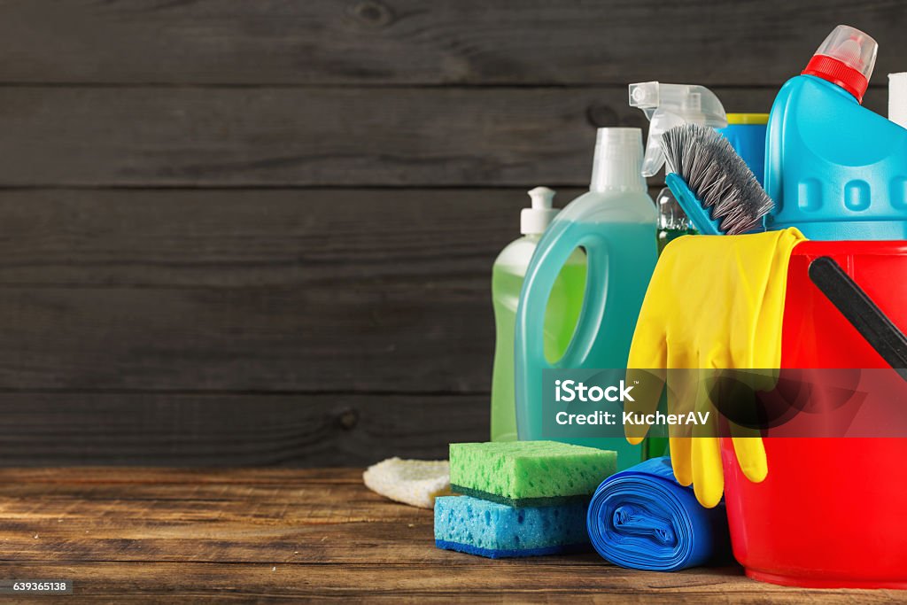 Basket with variety cleaning product with copy space Basket with variety cleaning product on wooden table with copy space Cleaning Stock Photo