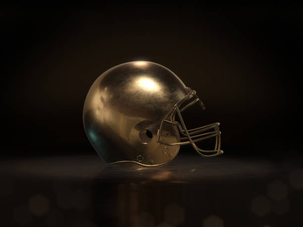 istock golden football helmet with dark background.3D rendering 639370430