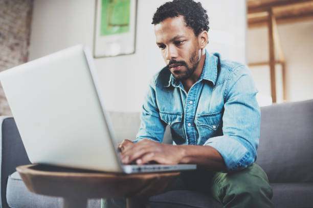 istock Concentrated bearded African man working at home while sitting on 639370534