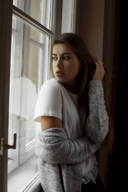 istock Sensual young model with long hair looking at the window 639372118