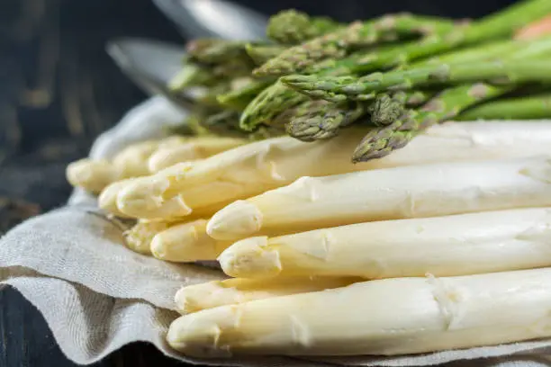 Spring season - fresh white and green asparagus on linen napkin