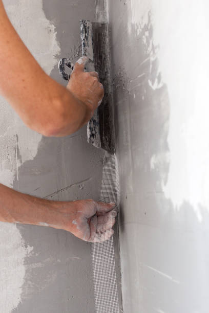 istock Worker applied with a spatula a solution of fiberglass mesh. 639372502