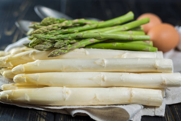istock Spring season - fresh white and green uncooked asparagus 639372764