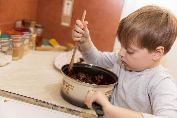 istock Little boy making cookies 639375016