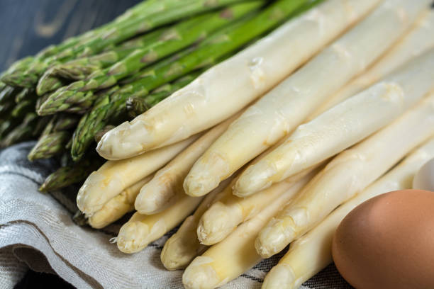 istock Spring season - fresh white and green uncooked asparagus 639375828