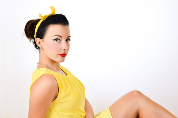 Cute pin up girl applying blusher, studio, beautiful
