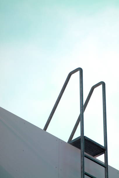 istock Roof access ladder with metal handholders. 639378022