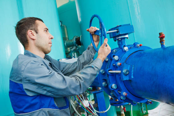 istock serviceman operating industrial water purification or filtration equipment 639378358