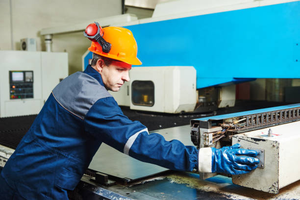 istock industrial factory worker operates punching machine 639383482
