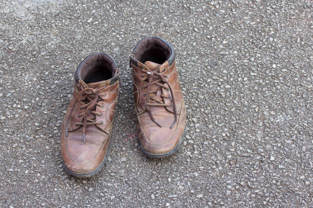 istock Old brown leather shoes on the floor. 639384548
