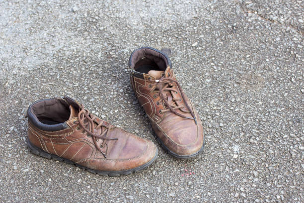 istock Old brown leather shoes on cement floor. 639384986