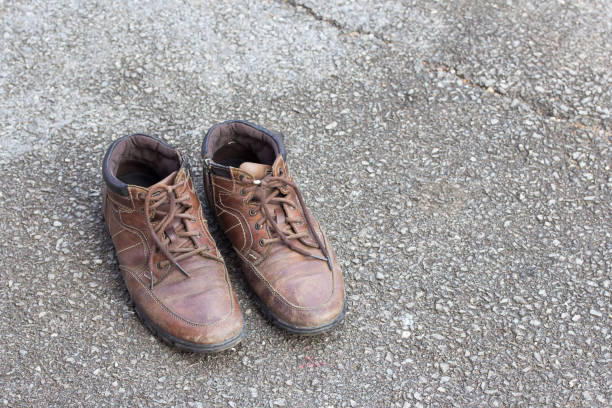 istock Old brown leather shoes on cement floor. 639385146