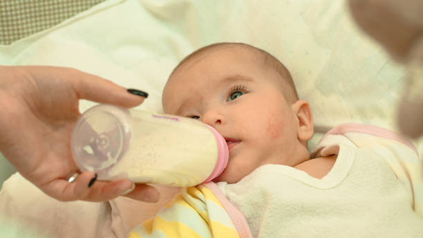istock Little newborn baby drinking milk from a bottle 639385244