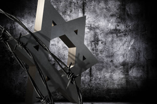 Shoah Day Memorial Conceptual background in memoriam of the Shoah Day, representing a granite star of David barbed wire. holocaust stock pictures, royalty-free photos & images
