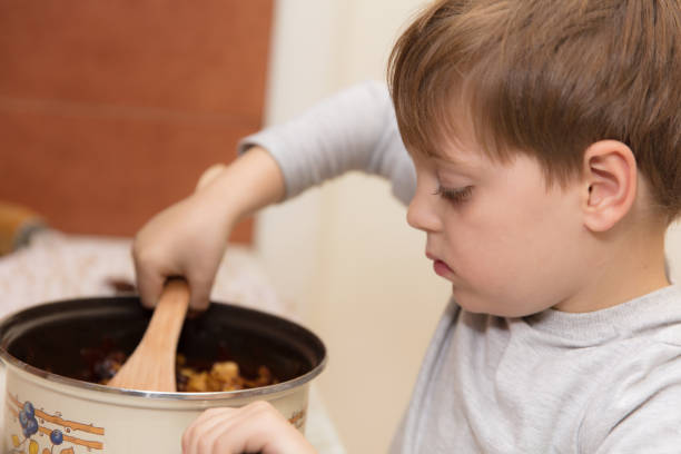 istock Little boy making cookies 639387796