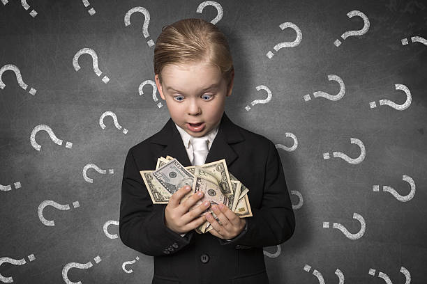 Boy in amazement holding money