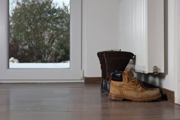 istock Heating radiator with warm winter boots indoor 639391914
