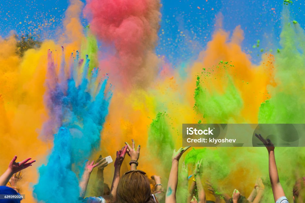 Color holi festival crowd of people throwing colored paint on Holi festival Holi Stock Photo